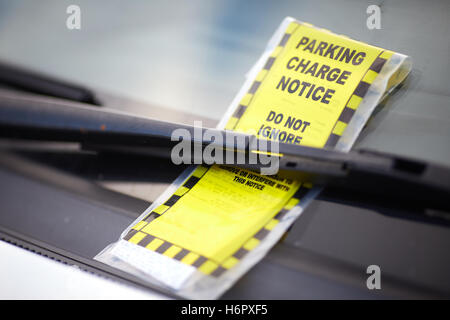 Parking charge notice stuck onto windscreen of a car Stock Photo