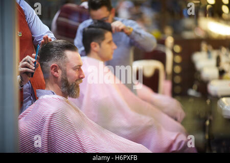 Gents barber hairdresser grooming male   busy street  Shops shopping shopper store retail retailer retail retailers traders trad Stock Photo