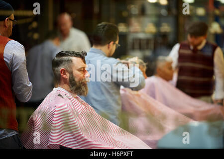 Gents barber hairdresser grooming male   busy street  Shops shopping shopper store retail retailer retail retailers traders trad Stock Photo