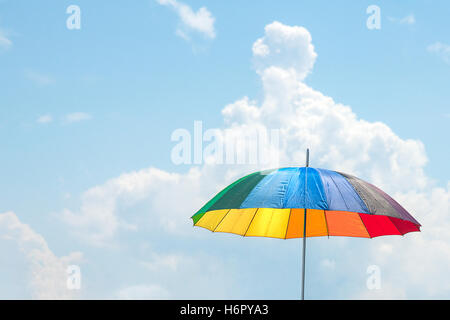 Colorful beach umbrella or parasol against the sunny sky Stock Photo