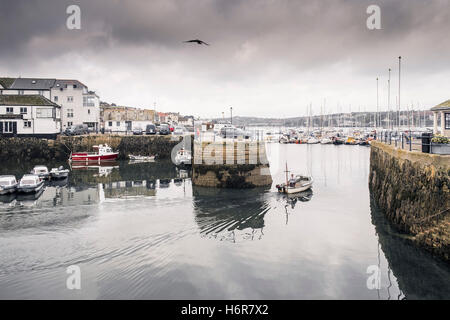 A small boat leaves the harbour at Custom House Quay in Falmouth, Cornwall. Stock Photo