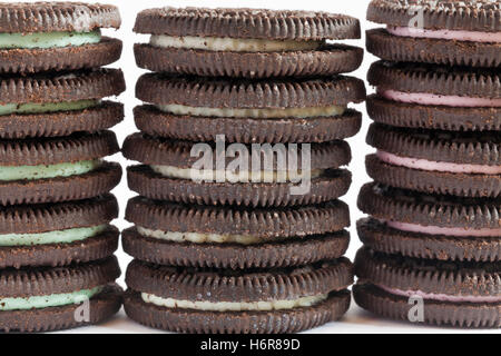 Stack of Mint flavour, Original flavour and Strawberry Cheesecake flavour Oreo biscuits set on white background Stock Photo
