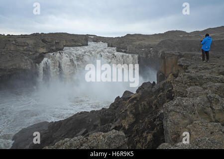 Tourist at Aldeyjarfoss, central Iceland. Stock Photo