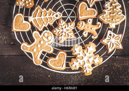 Christmas gingerbread cookies with icing on dark background. Stock Photo