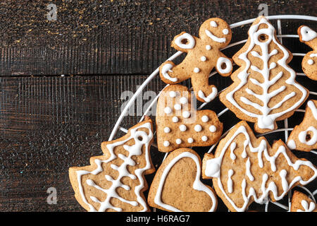 Christmas gingerbread cookies with icing on dark background. Stock Photo