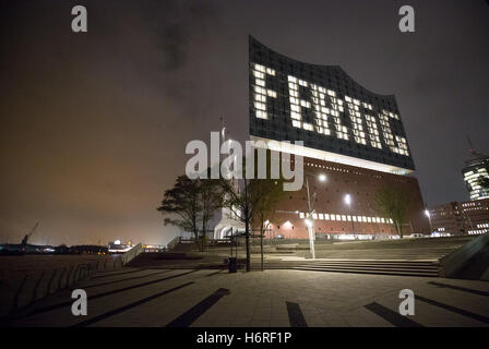 Hamburg, Germany. 31st Oct, 2016. The word 'Fertig' (lit. 'Done') can be seen on the facade via lights in specific windows of the Elbphilharmonie in Hamburg, Germany, 31 October 2016. The construction of the Elbphilharmonie in Hamburg is completed - roughly nine years after the laying of the foundation stone. The construction group Hochtief officially handed over the concert house to the city. It is said to open on 11 January 2017. PHOTO: CHRISTIAN CHARISIUS/dpa/Alamy Live News Stock Photo