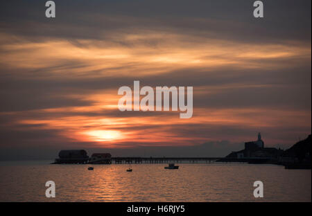 Swansea, UK. 01st Nov, 2016. 1st November 2016 - The sun rises over the seafront in the small fishing village of Mumbles near Swansea today. Credit:  Phil Rees/Alamy Live News Stock Photo