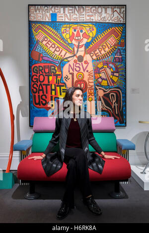 London, UK. 1st Nov, 2016. A staff member sits in front of 'Ewigkeitendegottt, Sein Engel' by August Walla, est. GBP6-8k. The first look of 'Bowie/Collector', artworks from the late David Bowie's personal art collection, ahead of their sale later this month at Sotheby's. Credit:  Stephen Chung/Alamy Live News Stock Photo