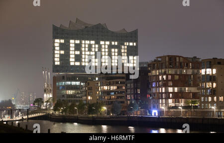 With several illuminated windows, the facade of the Elbphilharmonie spells out the word 'Fertig' (lit. 'Finished') in Hamburg, Germany, 31 October 2016. The Elbe Philharmonic Hall (Elbphilharmonie) is completed after nine years of construction work. The construction company Hochtief handed over the building to the city of Hamburg on monday. The official opening is planned for the 11 January 2017. Photo: Christian Charisius/dpa Stock Photo