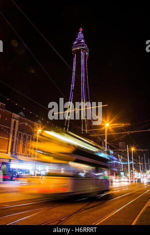 Blackpool Tower & passing traffic trails at night, Lancashire, UK. Lightpool Festival illuminations in Blackpool town centre has been transformed with more than 30 installations and sculptures, as the first Lightpool Festival gets under way in the resort. Stock Photo