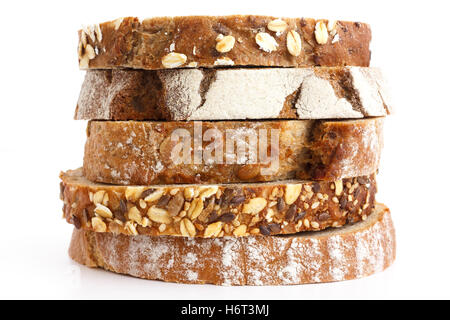 Mixed slices of health breads stacked. White surface. Stock Photo