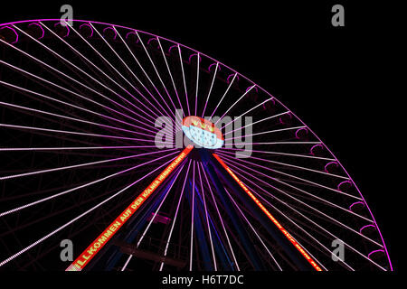 Big wheel in the night-time at autumn parish fair in Cologne, Germany Stock Photo