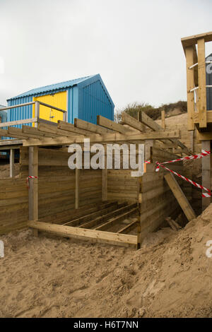 The wooden framework structure for a new beach hut being built on the  sandy beach at Abersoch on the Lleyn peninsula, Gwynedd North Wales UK. One of the huts on this beach sold for £130,000 at an auction in 2016 Stock Photo