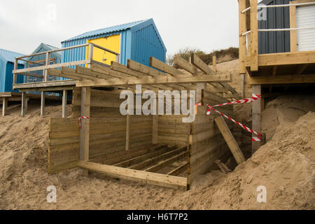 The wooden framework structure for a new beach hut being built on the  sandy beach at Abersoch on the Lleyn peninsula, Gwynedd North Wales UK. One of the huts on this beach sold for £130,000 at an auction in 2016 Stock Photo