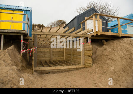 The wooden framework structure for a new beach hut being built on the  sandy beach at Abersoch on the Lleyn peninsula, Gwynedd North Wales UK. One of the huts on this beach sold for £130,000 at an auction in 2016 Stock Photo