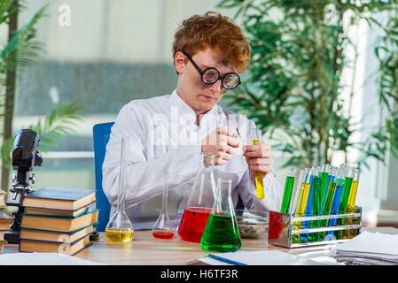 Young crazy chemist working in the lab Stock Photo