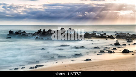 Ascension Island Rocks at Dead Man's Beach Georgetown at sunset artistic long exposure Stock Photo