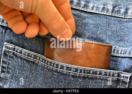 stealing a purse from a pocket Stock Photo