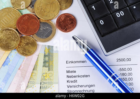 euro notes and coins with pen,table and calculator Stock Photo