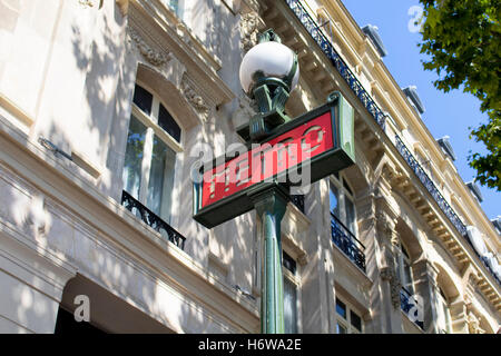 Traditional metro sign with old, historical building in the background in Paris. Stock Photo