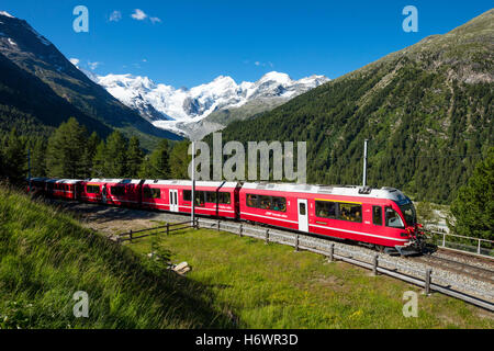 Bernina Express train beneath Morteratsch Glacier. Pontresina, Berniner Alps, Graubunden, Switzerland. Stock Photo