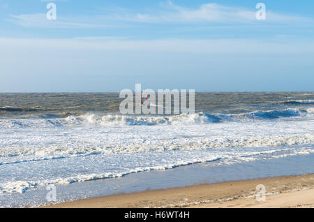 single wind surfer braving the waves on a rough north sea Stock Photo