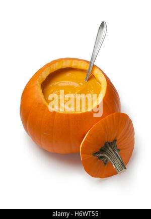Fresh made pumpkin soup in a orange pumpkin on white background Stock Photo