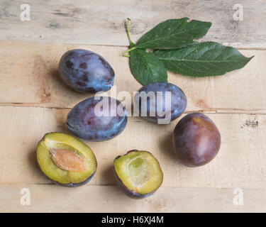 fresh plums on old wooden background Stock Photo