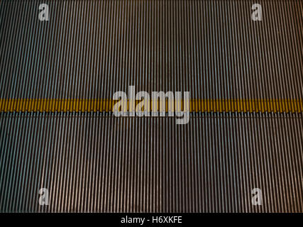 Metal escalator step texture, multiple stripes, yellow horizontal line Stock Photo
