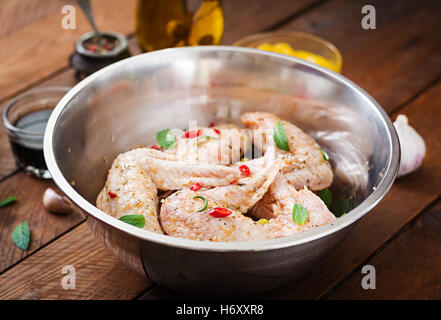 Raw marinated chicken wings prepared in Asian style with honey, garlic, soy sauce and herbs Stock Photo