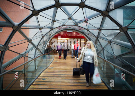 Manchester glass walkway Arndale connect   Shoppers walk through glass tunnel connecting Manchester Arndale centre  Marks Spence Stock Photo