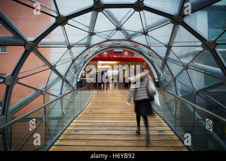 Manchester glass walkway Arndale connect   Shoppers walk through glass tunnel connecting Manchester Arndale centre  Marks Spence Stock Photo