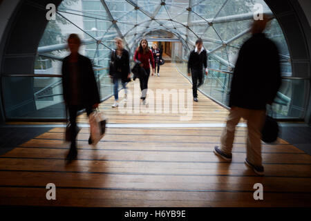 Manchester glass walkway Arndale connect   Shoppers walk through glass tunnel connecting Manchester Arndale centre  Marks Spence Stock Photo