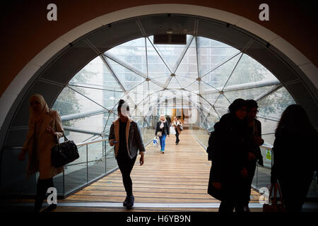 Manchester glass walkway Arndale connect   Shoppers walk through glass tunnel connecting Manchester Arndale centre  Marks Spence Stock Photo