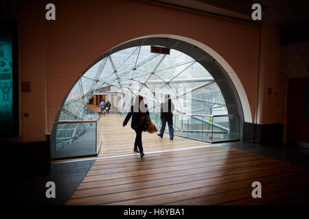 Manchester glass walkway Arndale connect   Shoppers walk through glass tunnel connecting Manchester Arndale centre  Marks Spence Stock Photo