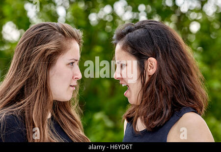 Two girls having a disagreement and argueing with one another Stock Photo