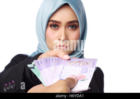 a photo of woman holding a bribery money isolated in white background Stock Photo