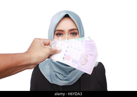 a photo of woman holding a bribery money isolated in white background Stock Photo