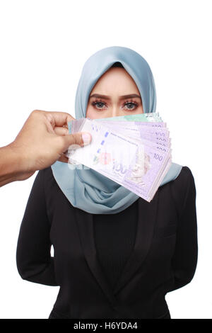 a photo of woman holding a bribery money isolated in white background Stock Photo