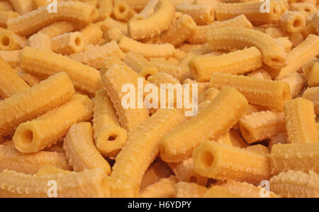 yellow macaroni dry fresh pasta in the shape of small tubes Stock Photo