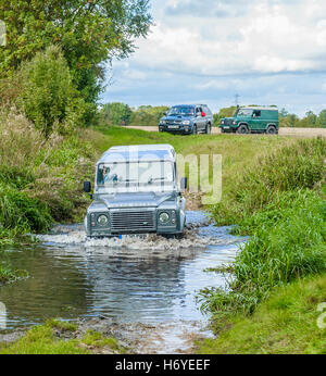 A Landrover 110 crossing, or fording, a stream or river Stock Photo