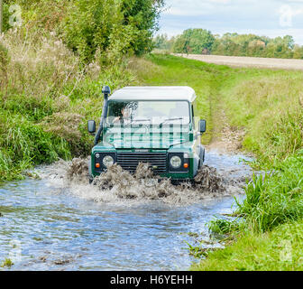 A Landrover Defender 90 crossing, or fording, a stream or river Stock Photo