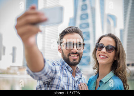 Tourist couple taking smartphone selfie, Dubai, United Arab Emirates Stock Photo