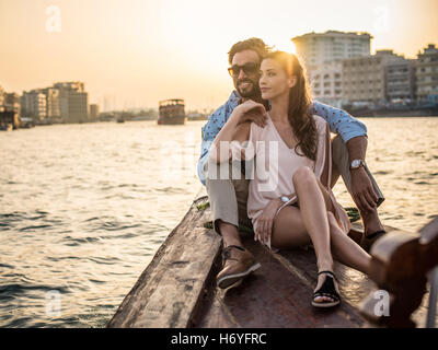 Romantic couple sitting on boat at Dubai marina, United Arab Emirates Stock Photo