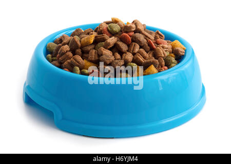 Dry cat food in blue bowl isolated on white. Stock Photo