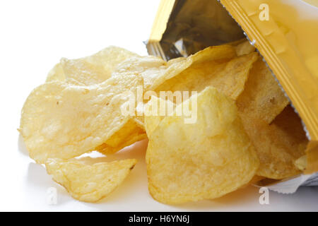 Potato crisp packet opened with crisps spilling out Stock Photo