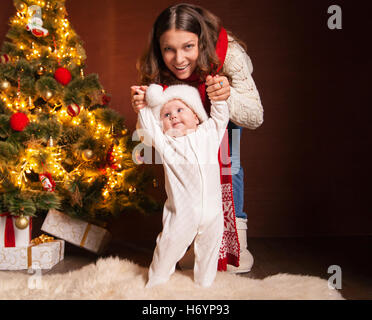 Happy family near Christmas tree at home Stock Photo