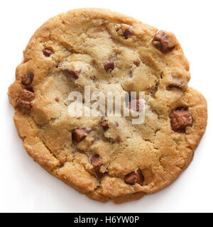Large light chocolate chip cookie on a white surface shot from above Stock Photo