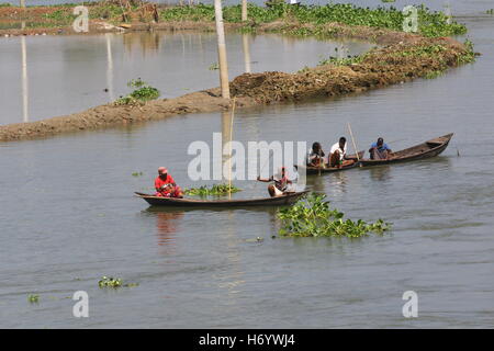 Seasonal fishermen busy fishing in the Turag river at Savar outside the capital Dhaka, with the river's water level going down. Stock Photo