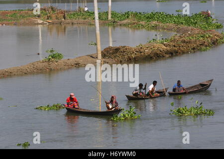 Seasonal fishermen busy fishing in the Turag river at Savar outside the capital Dhaka, with the river's water level going down. Stock Photo